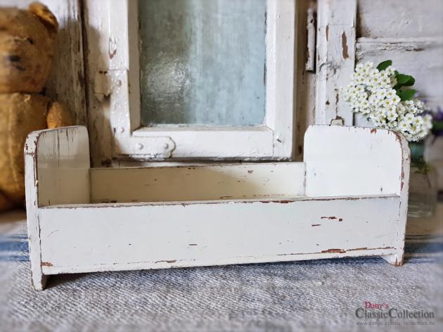 white wooden dolls bed